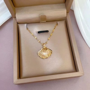 Elegant gold hollow shell pendant necklace with pearl on champagne jewelry box