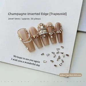 Macro shot of 2x3mm champagne trapezoid nail rhinestones on long ballerina fake nails