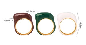Detail showing colorful oil drip enamel finish on 18k gold plated stainless steel rings
