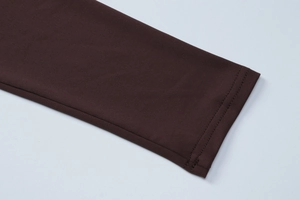 Close-up of the dark brown sleeve cuff with premium double-stitch seam detail