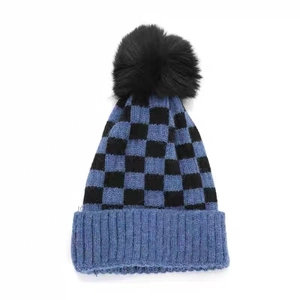 Winter checkered knit beanie with a faux fur pompom in navy blue and black colors