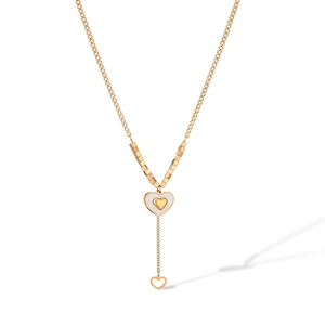 Detail view of a gold Y-shaped necklace featuring a double-layer heart pendant in white