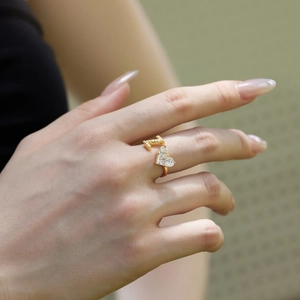 Detail shot of gold S925 silver open ring featuring letter L and heart zircon on hand
