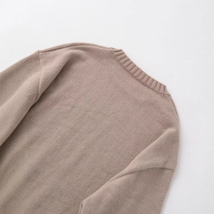 Oatmeal knitted sweater back view featuring vertical ribbed neckline and dense texture