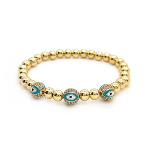 18K gold beaded bracelet featuring three evil eye charms with blue enamel and zircon stones