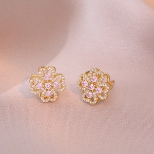 Detailed close-up of clover flower stud earrings with pink and white cubic zirconia
