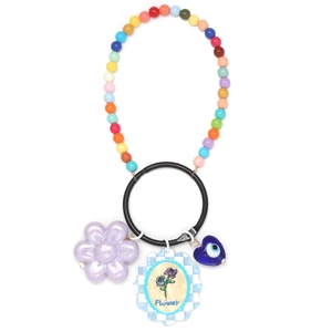 Close-up of colorful beaded keychain with blue evil eye and purple flower charm charms
