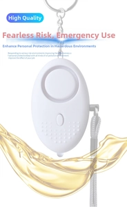 Close-up of white egg-shaped personal security alarm with metal keychain and woven strap