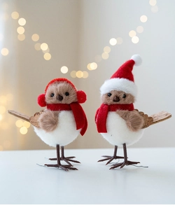 Detail of plush Christmas bird figurines with knitted ear muffs and red Santa hats