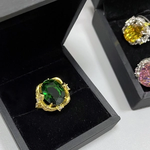 Detailed macro shot of three luxury oversized gemstone rings in a black jewelry box
