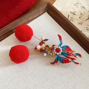Traditional Chinese gold fish hair clip with red pom poms and pearls for festive style
