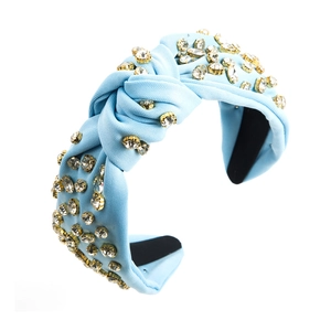 Detail of light blue knotted headband with hand-set sparkling crystals on gold settings