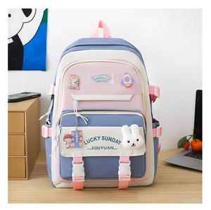 Close-up of cute school backpack with plush rabbit pendant and Lucky Sunday badges