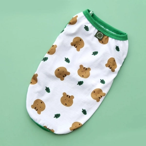 Close-up of a white pet vest with cartoon bear patterns and green ribbed neckline