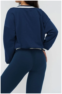 Detail of the high-quality navy blue tracksuit featuring textured ribbing and loose fit