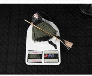 Halloween witch hanging decoration with green mesh dress weighing 22g on a digital scale