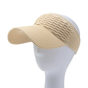 Detail of beige knitted visor showing high-elasticity ribbed fabric and long brim structure