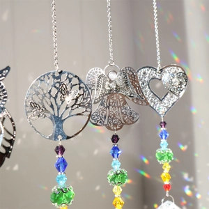 Silver Tree of Life, Angel, and Heart suncatchers with colorful crystals casting rainbow light