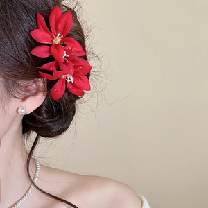 Detailed view of red fabric flower hairpins with elegant dewdrop texture for women