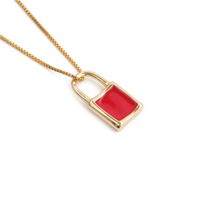 Detail of gold-plated padlock pendant with red enamel on a fine box chain necklace