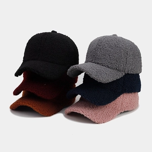 Close-up of thick sherpa fleece baseball caps in six assorted colors with fuzzy texture
