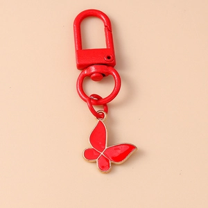 Detailed view of red butterfly pendant with golden edges on alloy metal keychain
