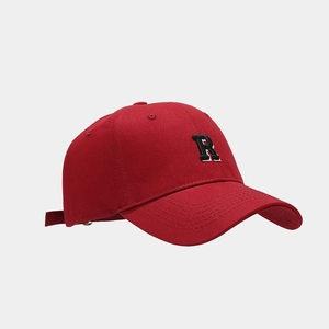 Close-up of red baseball cap featuring detailed black letter R embroidery on front