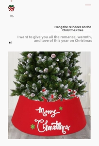 Detail of red Merry Christmas tree skirt featuring white embroidery and green snowflakes