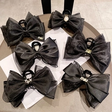 Detail shot of various black velvet hair clips with pearls and rhinestones on a table