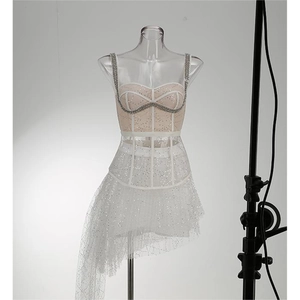 Detailed view of white sequins and sheer mesh fabric on a sexy slim fit bodycon dress