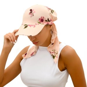 Pink floral baseball cap with matching scarf detail on fashion model in studio