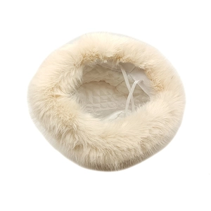 Plush cream faux fur bucket hat for winter with thick warm lining and adjustable cord
