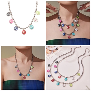 Detail showing multi-color enamel celestial pendants on a silver bead chain necklace