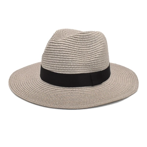 Close-up of fine paper straw texture and black ribbon detail on this stylish fedora hat