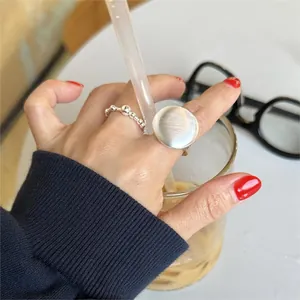 Close-up of 925 sterling silver beaded and brushed metal rings worn on the finger