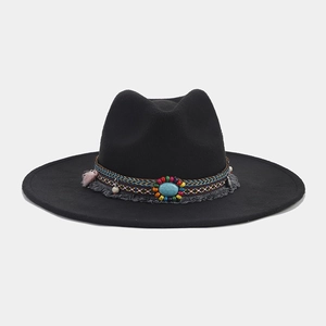 Detailed view of bohemian fedora with colorful woven band, turquoise stone, and tassels