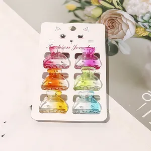 Detailed set of 6 colorful gradient mini hair claws displayed on a cat-themed card