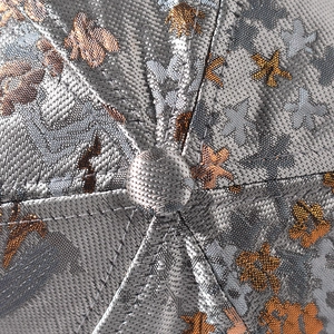 Macro detail of Chinese style golden jacquard fabric on the top of the baseball cap