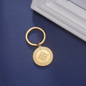 Detailed macro view of golden stainless steel Celtic knot pendant on a keychain