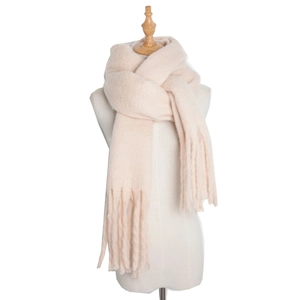 Detailed texture of beige mohair scarf with soft plush cable knit and elegant tassels
