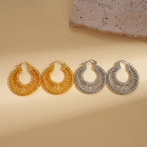 18k gold and silver plated woven hollow hoop earrings on a decorative stone base