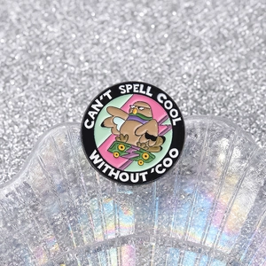 Round enamel pigeon on skateboard pin badge with 'CAN'T SPELL COOL WITHOUT COO' text