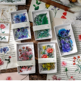 Detailed view of floral PET stickers in vintage boxes for journaling and DIY crafts
