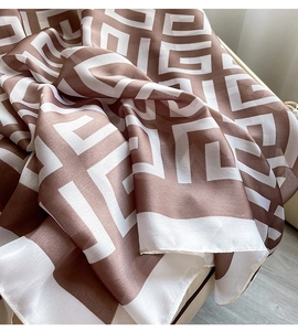 Macro shot of brown and white geometric chain-link patterned lightweight silk scarf fabric
