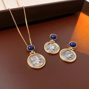 Detailed macro view of vintage Roman coin jewelry set with blue gemstones and gold trim