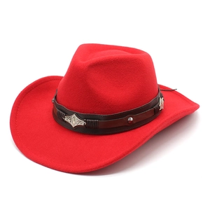Macro view of red felt cowboy hat featuring dark brown leather band and silver buckle