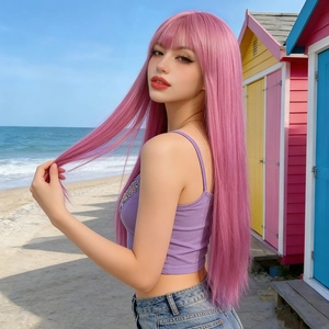 Detailed view of long straight pink wig with bangs against a sunny beach background