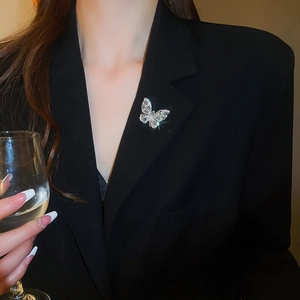 Close-up of luxury water drop zircon butterfly brooch on a black blazer jacket