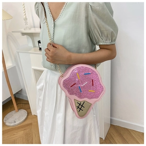 Detail of pink glitter ice cream cone crossbody bag with gold chain and sprinkles