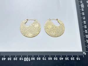 Detail showing 35mm hammer-textured 18K gold plated hoop earrings on a measuring scale
